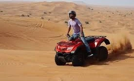 Riders on quad bikes during desert safari